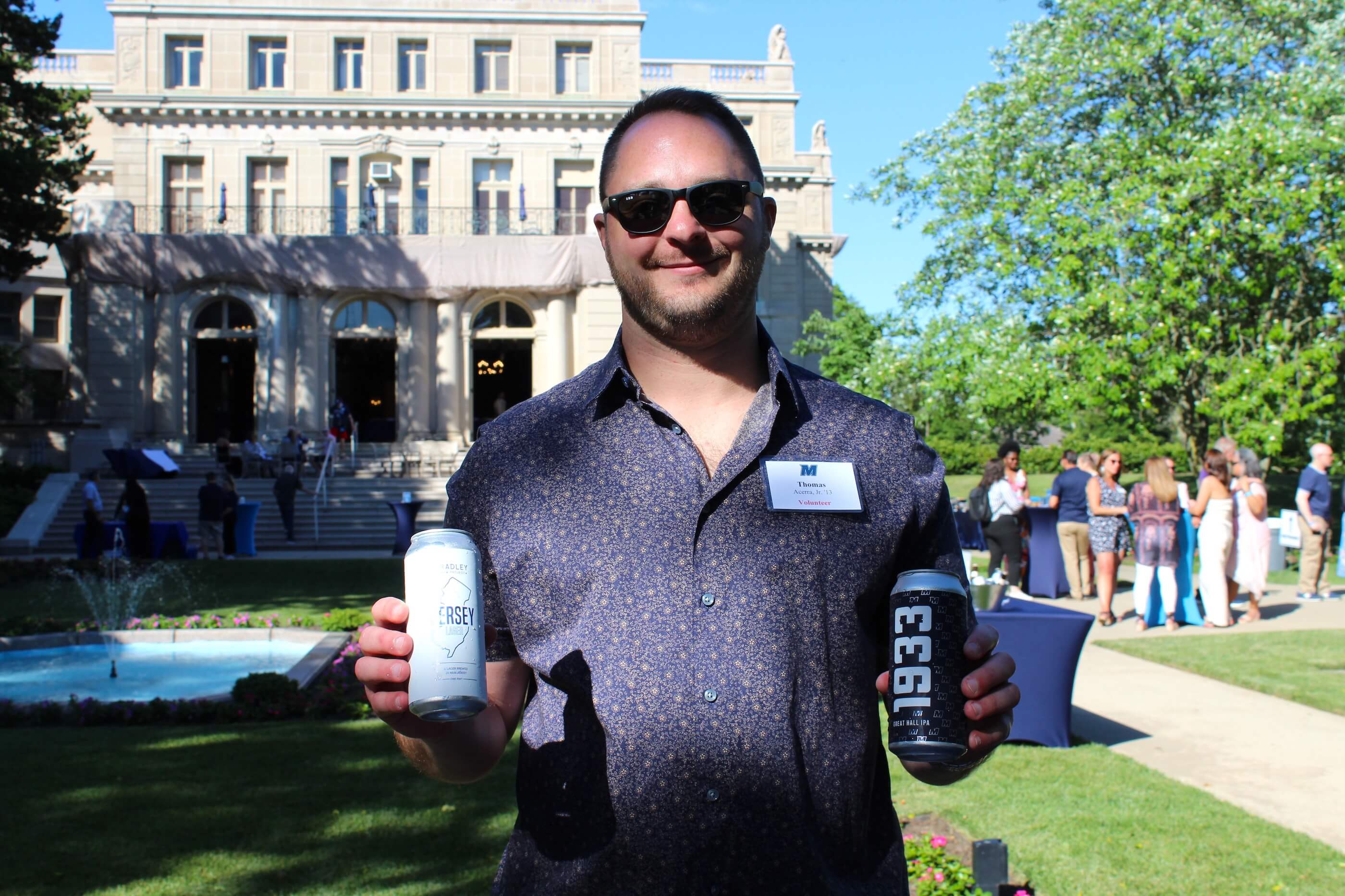 Man holding two beers in his hand, one lager and one IPA