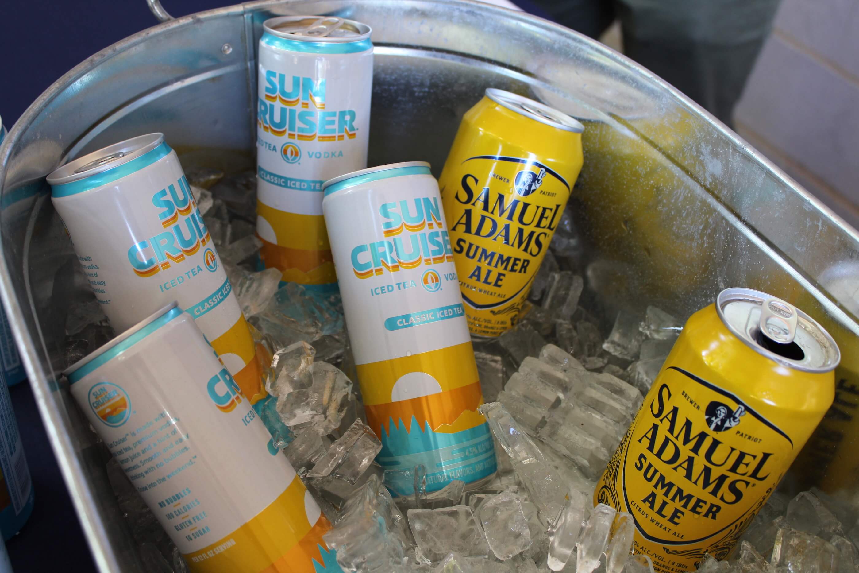 A bucket of canned beverages, including Sun Cruisers iced tea and vodka, and Samuel Adams Summer Ale beer.