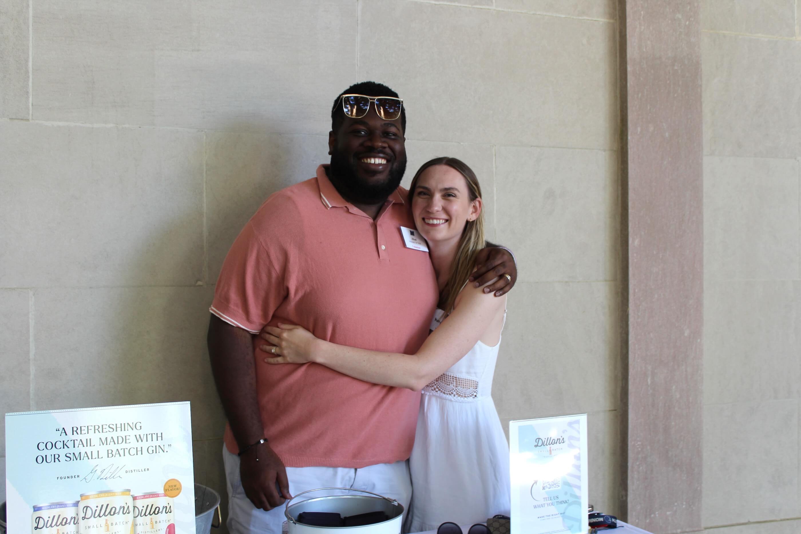 Two people posing for a photo by the Dillon's Small Batch Distillers table