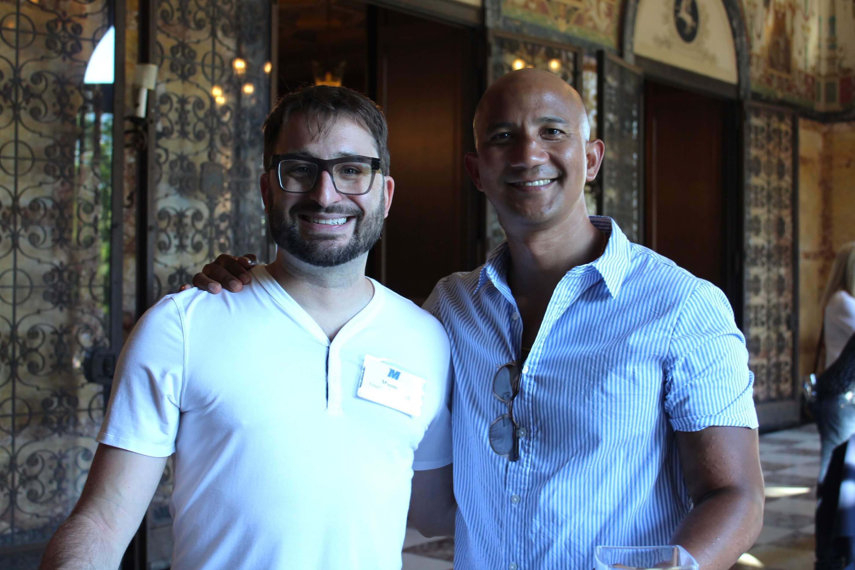 Two people posing for a photo, smiling, in the Great Hall