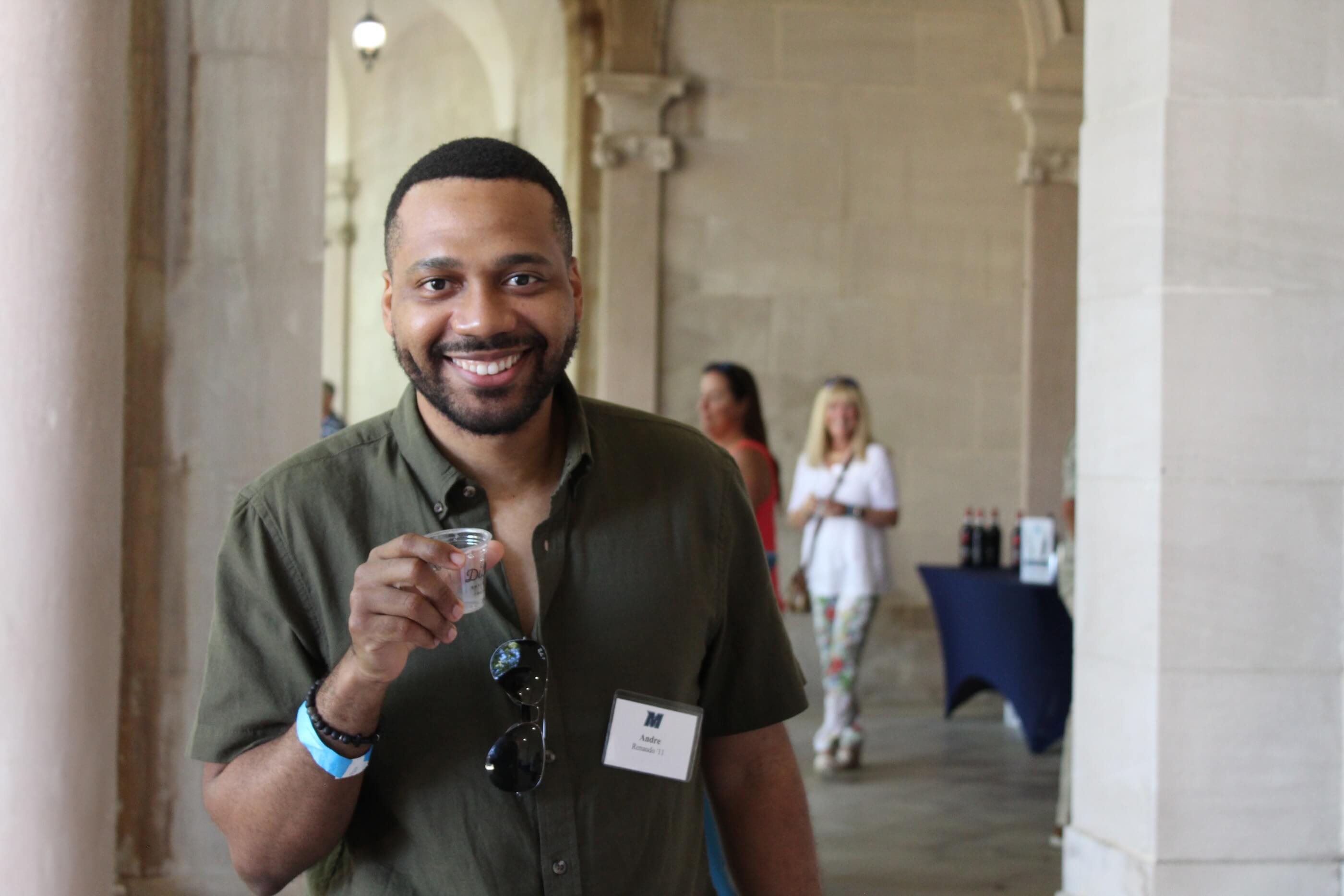 Attendee holding up empty tasting glass to camera