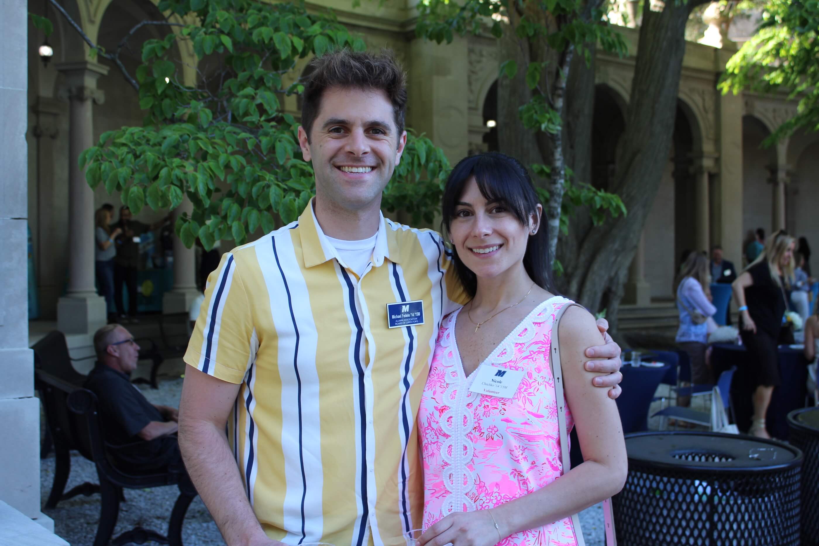 Two event participants posing for a photo in one of the shaded areas of Erlanger Gardens