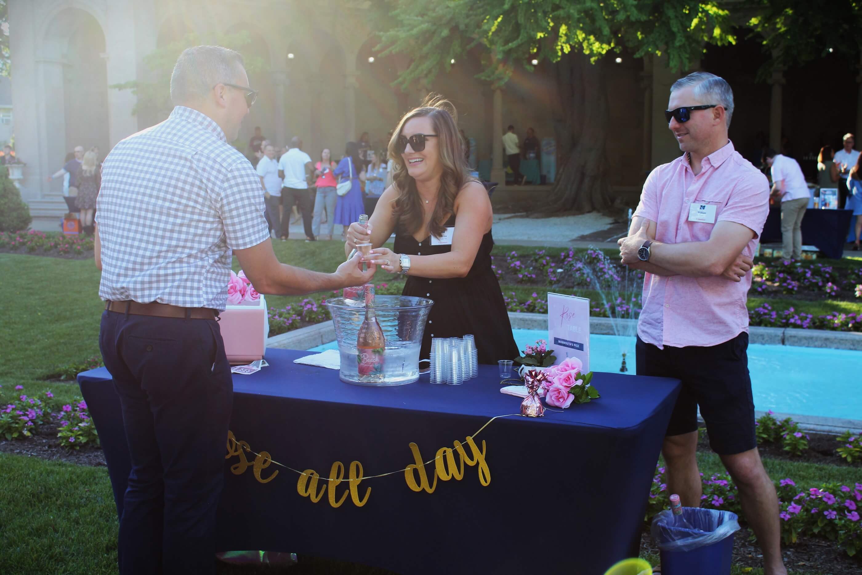 An attendee gets their tasting glass filled at a wine table