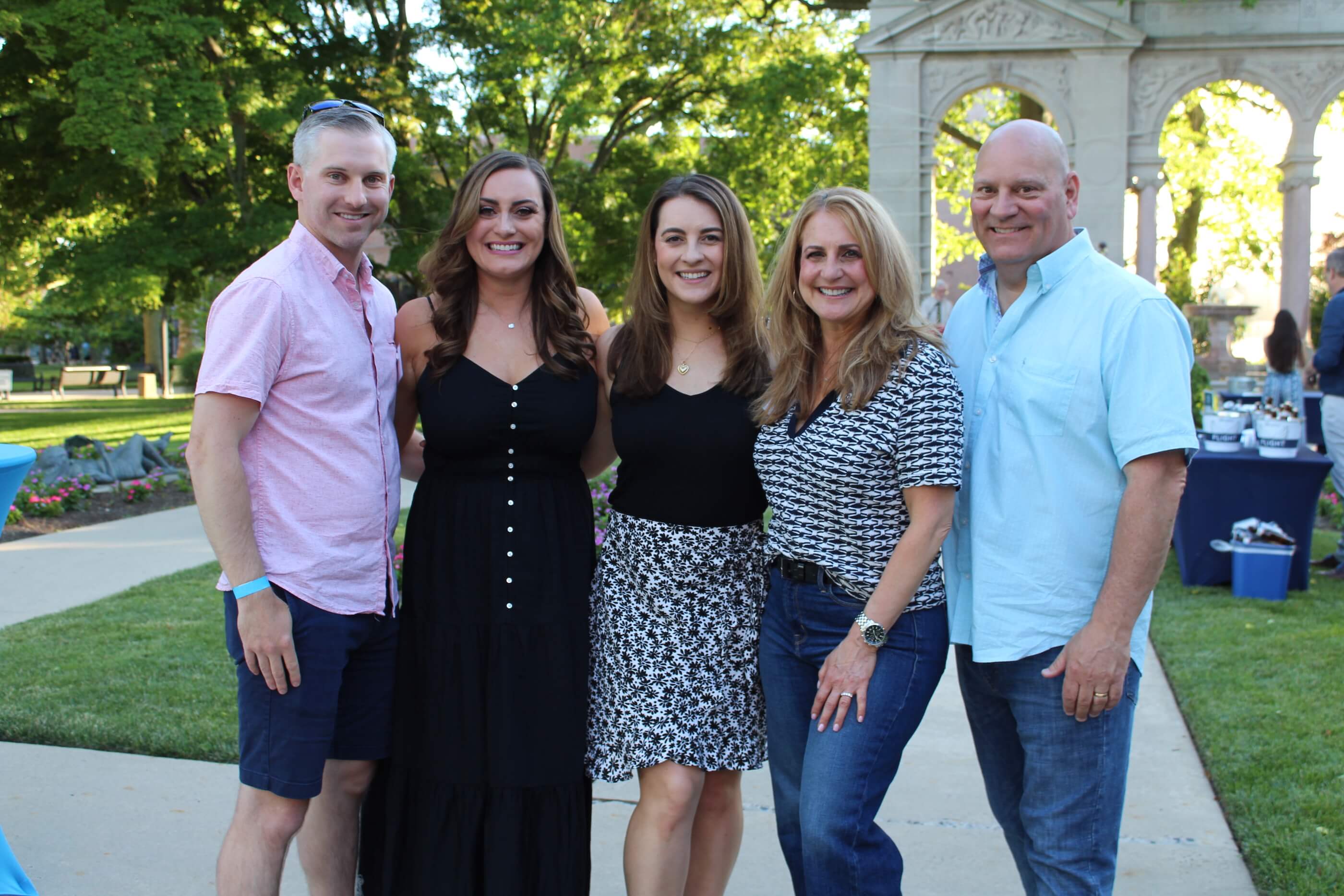 Five people posing for a group shot in Erlanger gardens