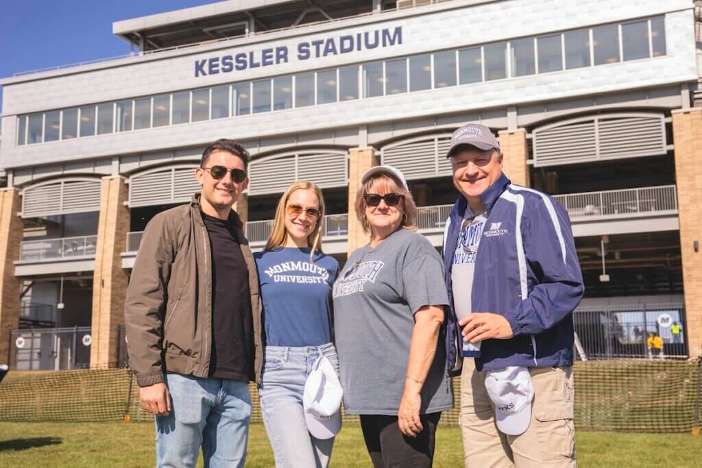 Two couples smiling together outside the stadium