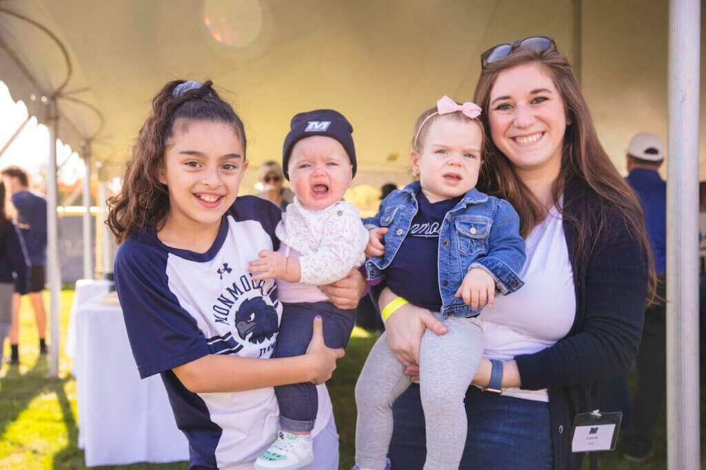 Two girls holding babies