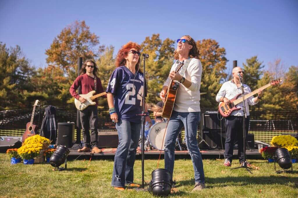 Live band, with guitarist and vocalist singing into the mic