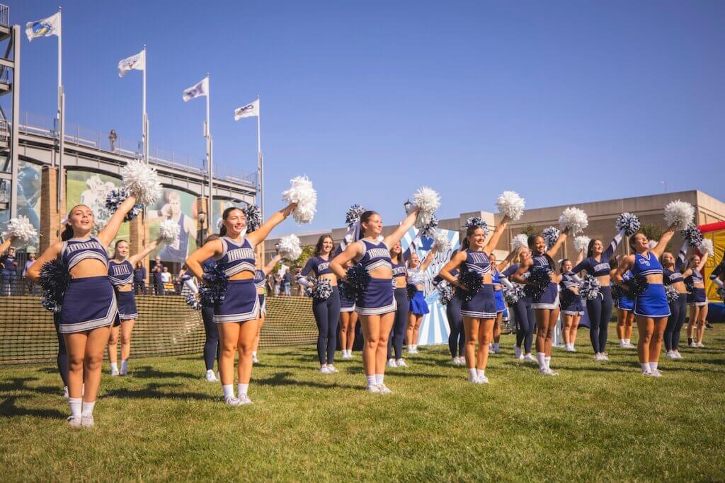 Cheerleaders performing a routine outside the stadium