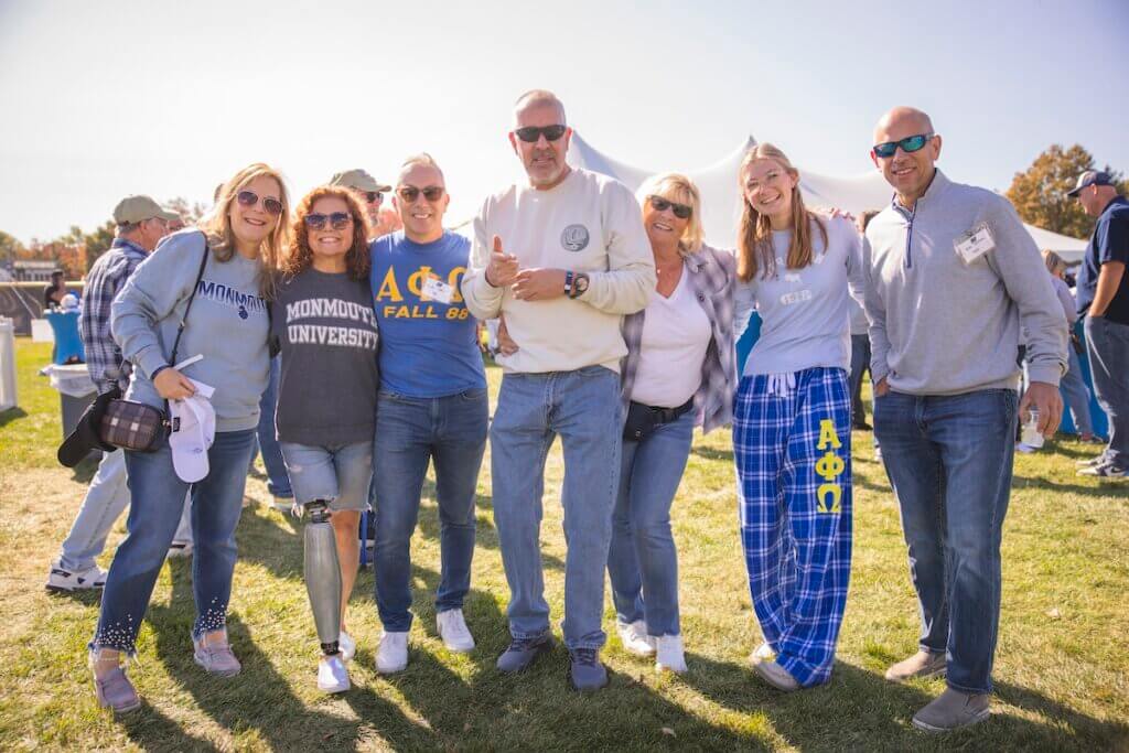 Family of eight people posing at the tailgate