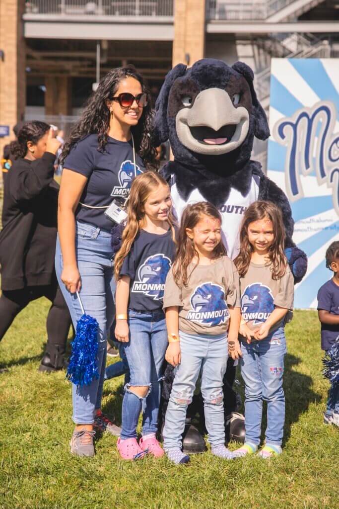 Mother and daughters pose with Shadow the hawk