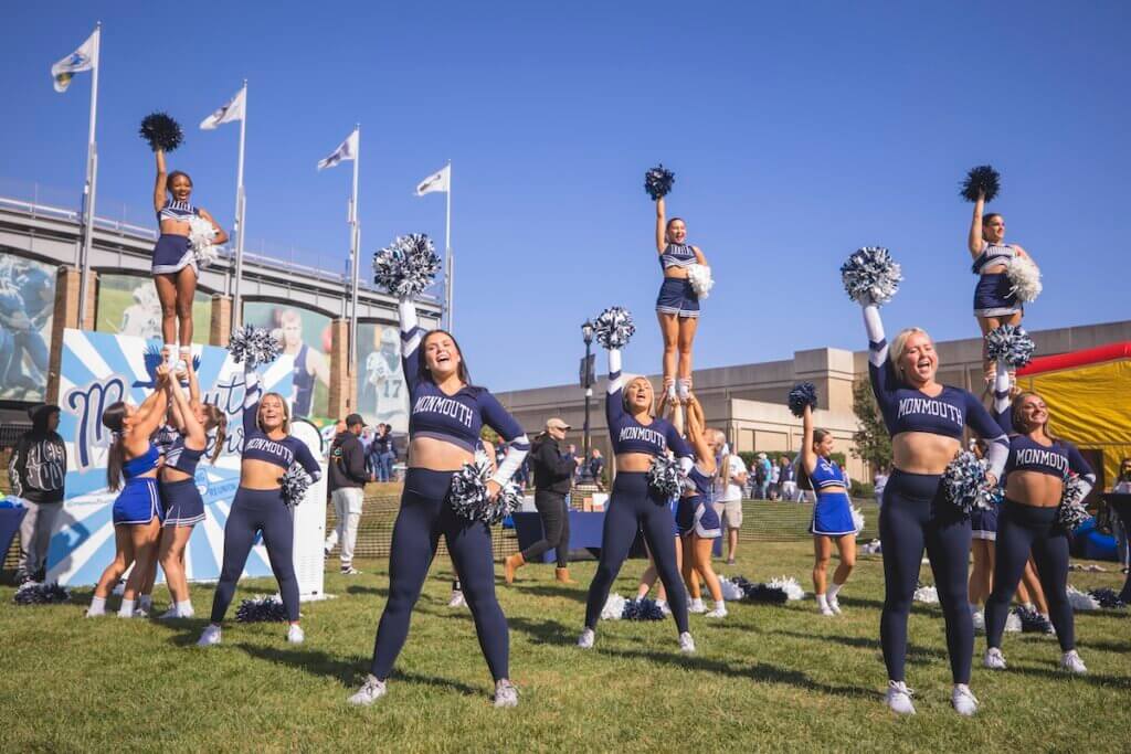 spirit squad performing dance moves in front of monmouth stadium