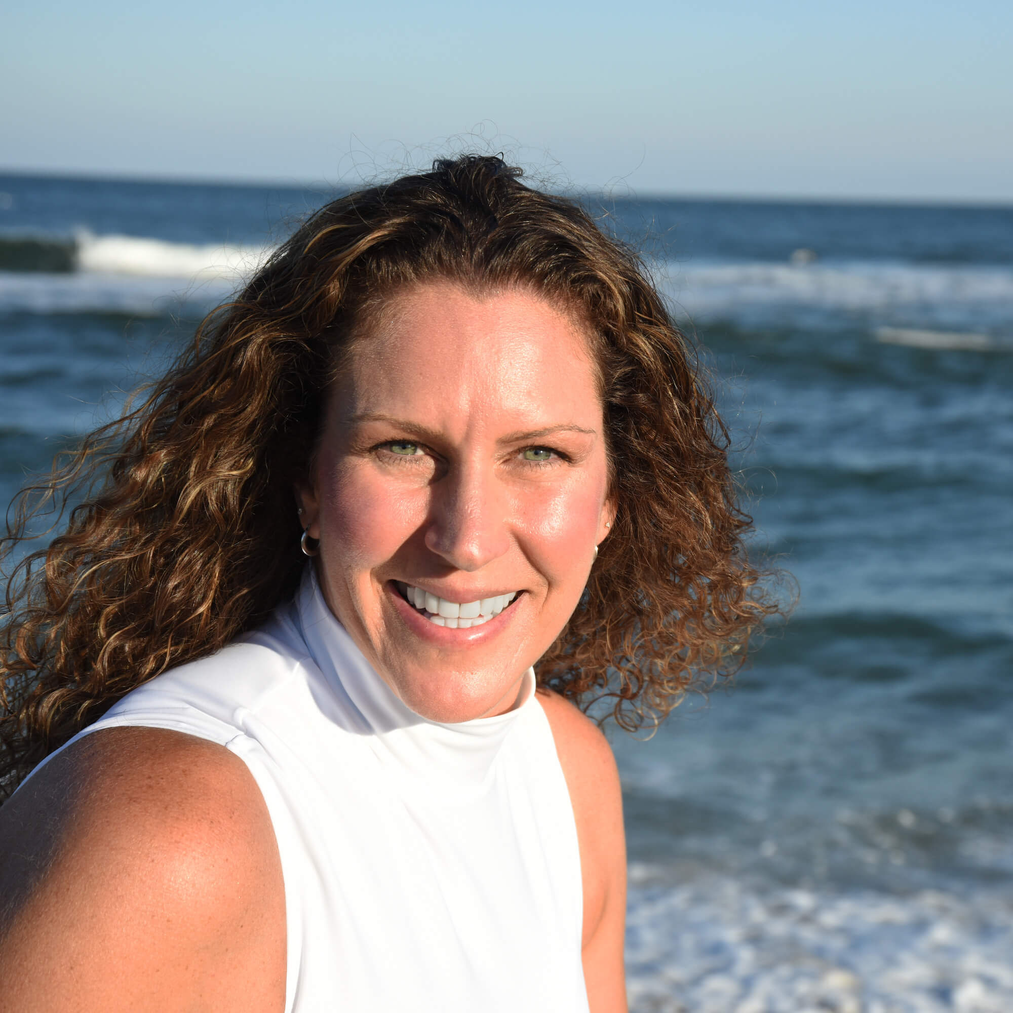Dawn Schultz smiling in front of the ocean