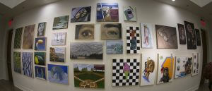 A fisheye lens shot of paintings hanging on a wall