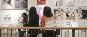 Gallery visitors observing student art