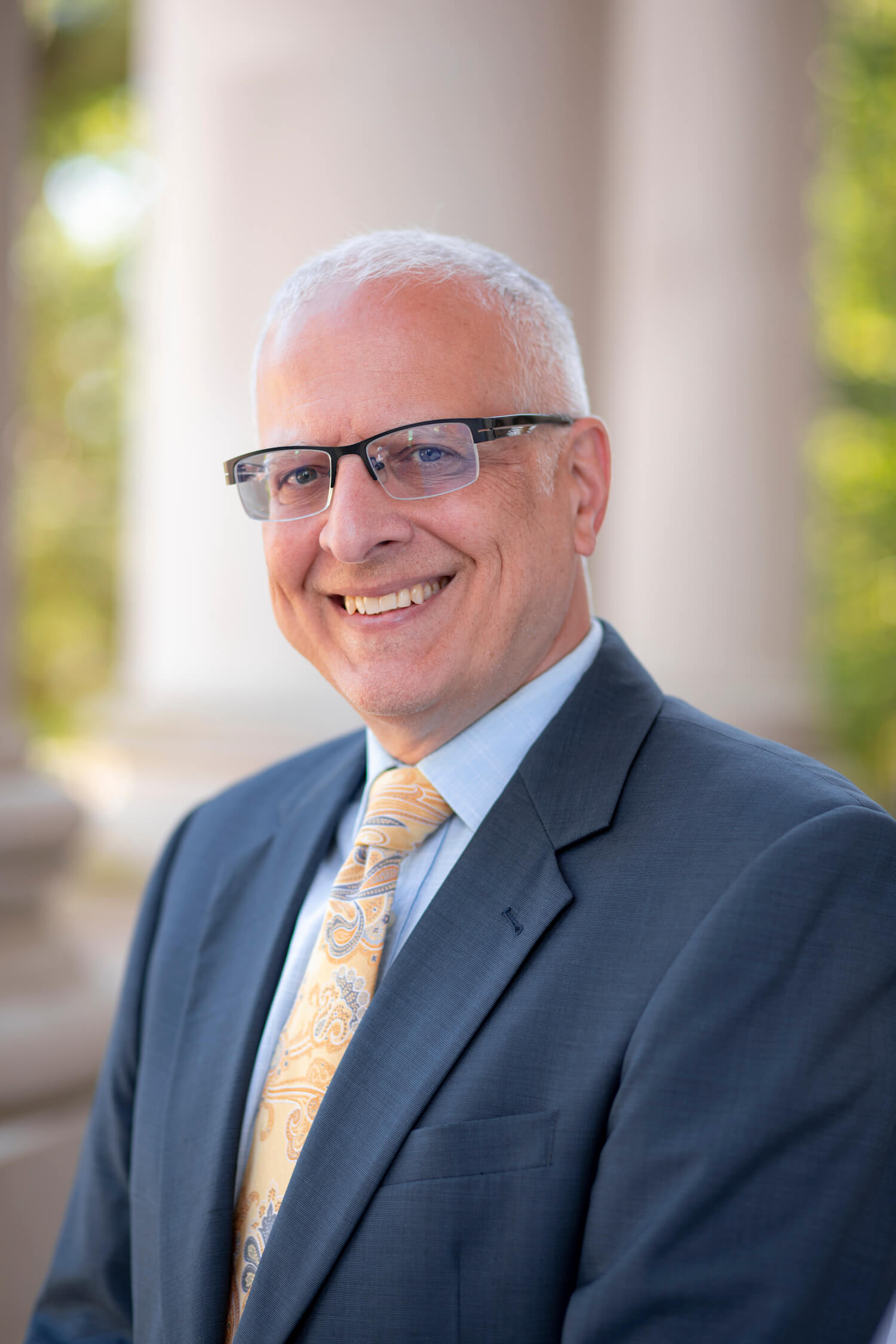 Headshot of Patrick Murray with building columns behind him