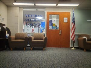 Door to Student Veterans Lounge with American flag.