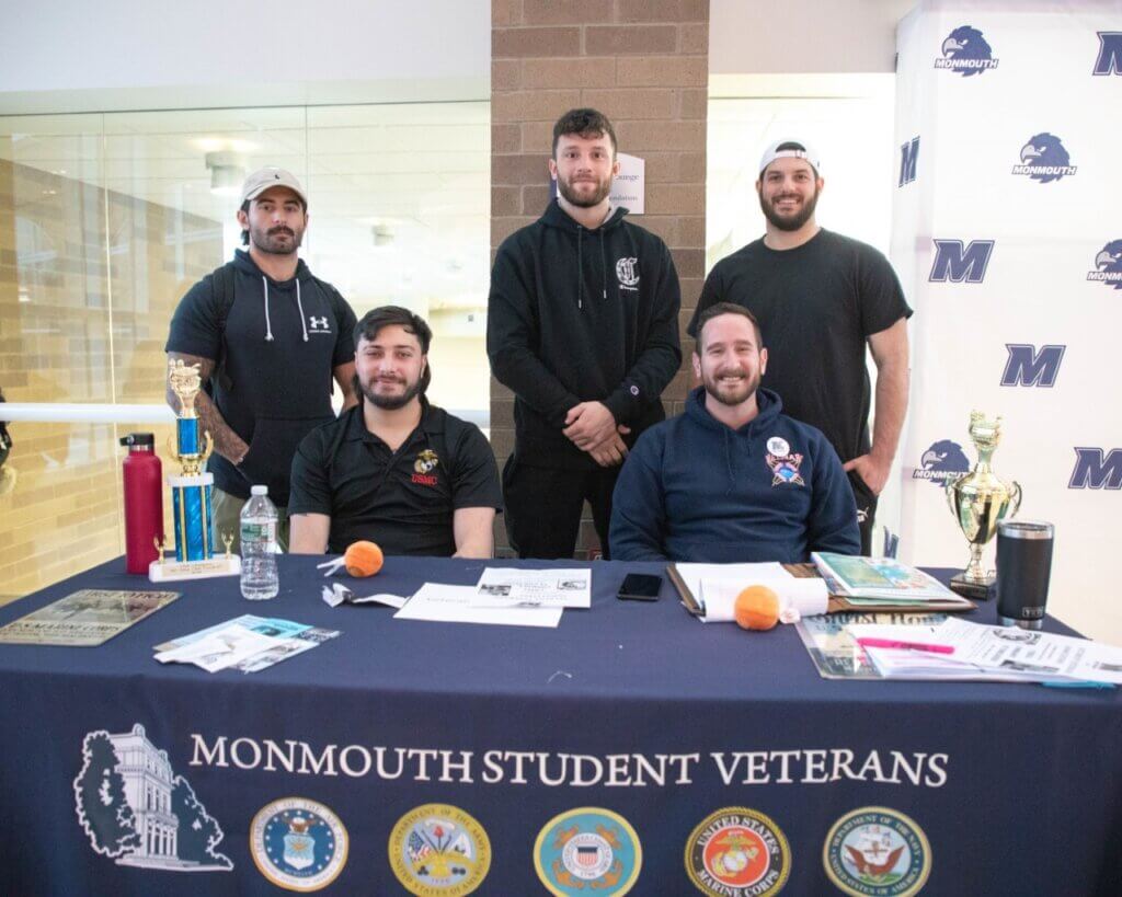 5 student veterans tabling at an event