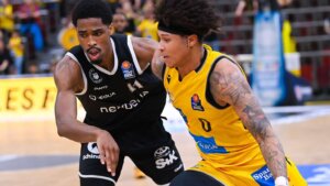 Deion Hammond '21 in yellow uniform shown playing basketball in Germany