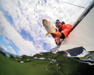 John Tiedemann holding a stiped bass fish