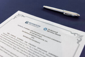 Close up view of strategic affiliation agreement contract and silver pen used to sign it