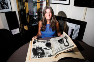 Eileen Chapman poses with material from the Bruce Springsteen Archives at Monmouth University