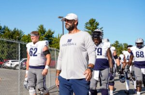 Jeff Gallo '05 walks with members of football team