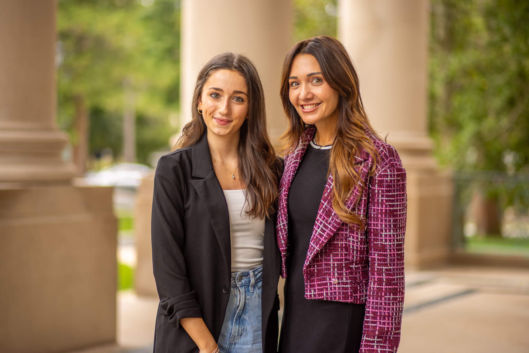 Two women standing outside the Great Hall on Monmouth University's campus