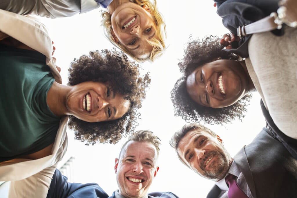 Image of people in circle looking down at camera.