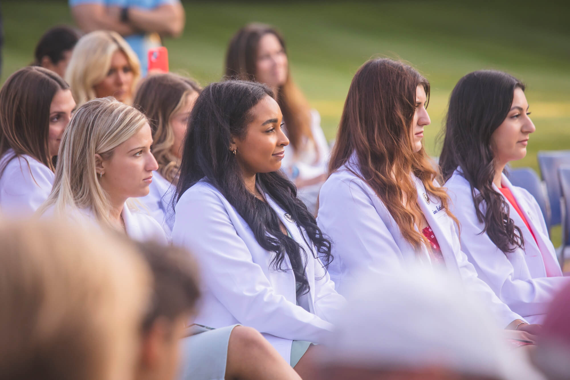 Nursing graduates look on during their pinning ceremony